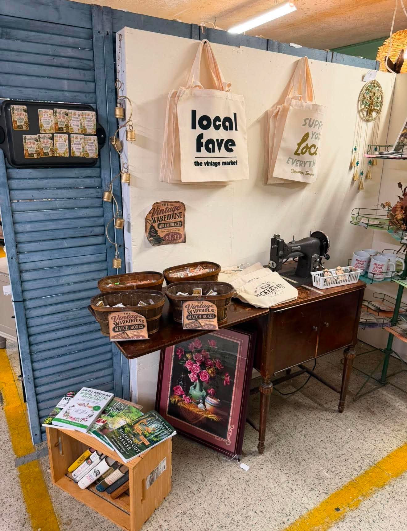 The Vintage Warehouse local-favorite totes, matchboxes and store goods displayed on a sewing table