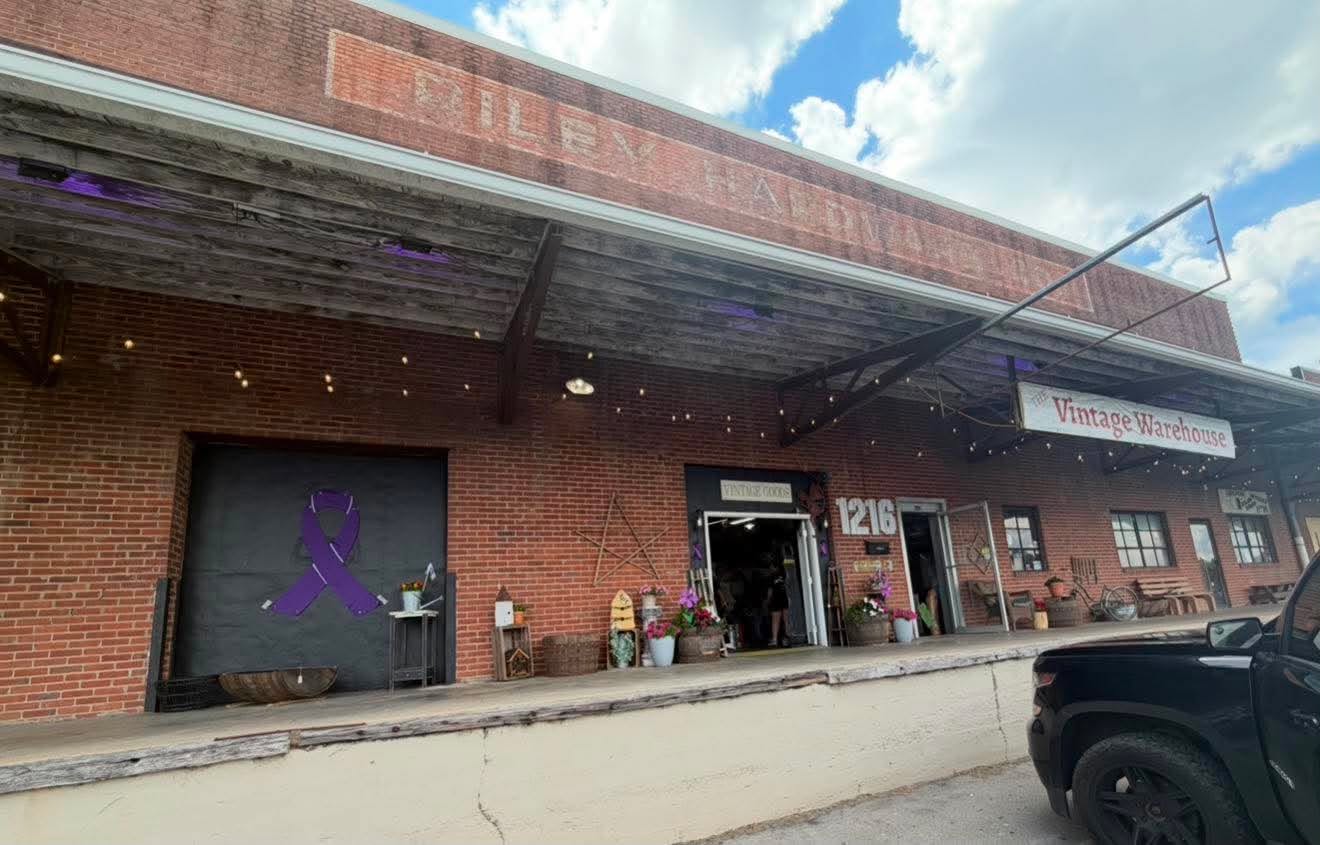 The brick exterior and loading dock entrance of The Vintage Warehouse at 1216 College Street